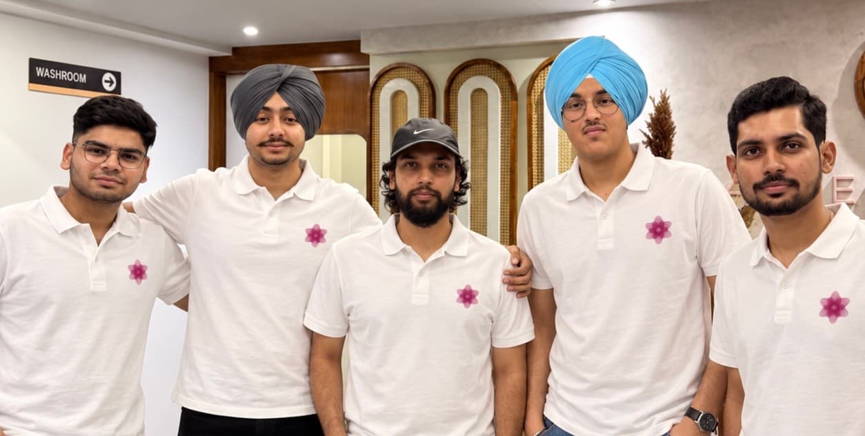 The Nureli team of five in matching white polos with the Nureli flower logo